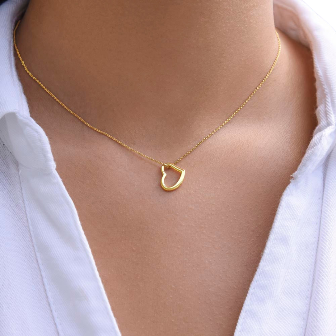 Imagine her delight when she sees this beautiful Delicate Heart Necklace, lovingly crafted in sterling silver and dipped in 14k white gold or 18k yellow gold for added luxury. This piece is pure elegance wrapped up in timeless simplicity. Trends may come and go, but this piece will last a lifetime with its classic subtle beauty.