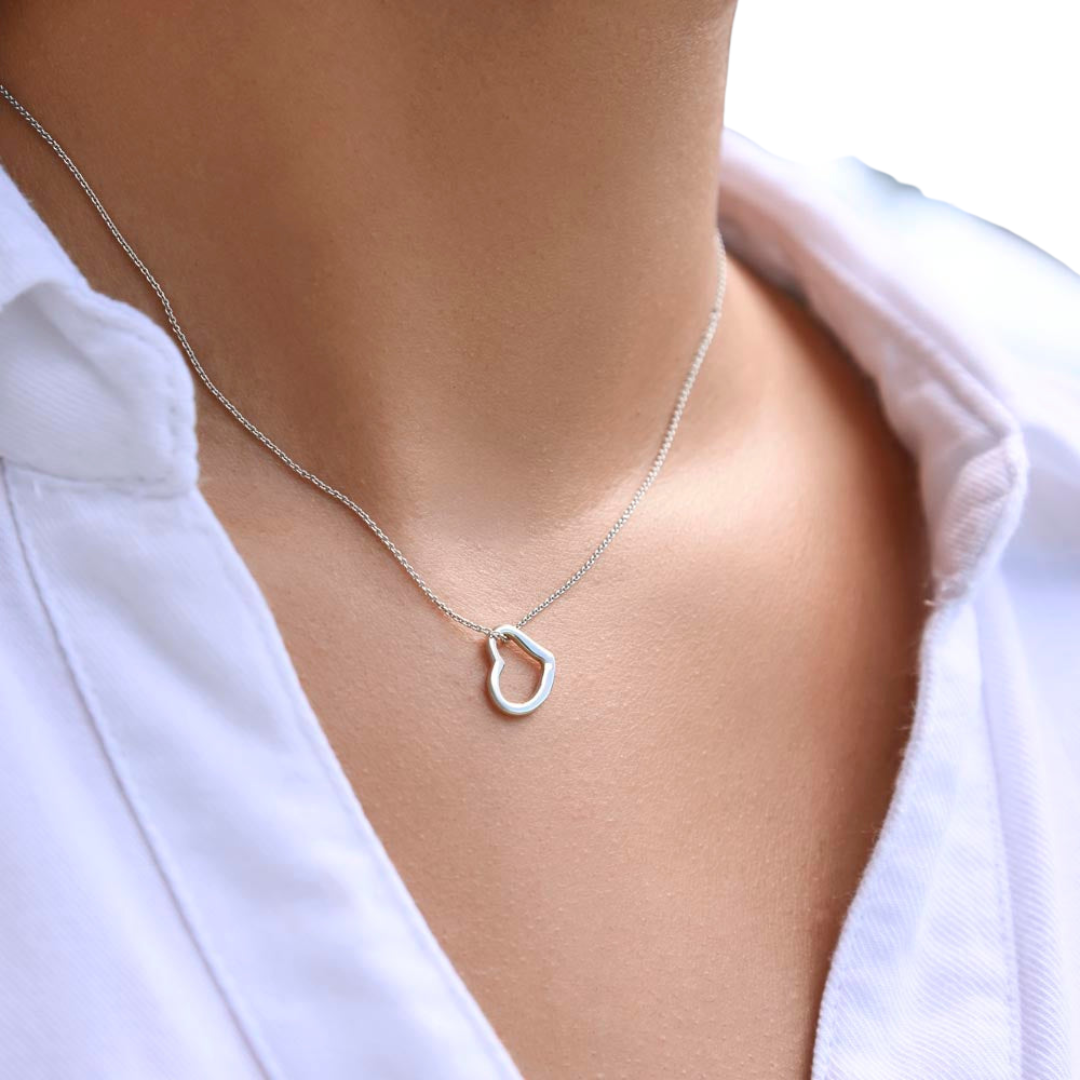 Imagine her delight when she sees this beautiful Delicate Heart Necklace, lovingly crafted in sterling silver and dipped in 14k white gold or 18k yellow gold for added luxury. This piece is pure elegance wrapped up in timeless simplicity. Trends may come and go, but this piece will last a lifetime with its classic subtle beauty.