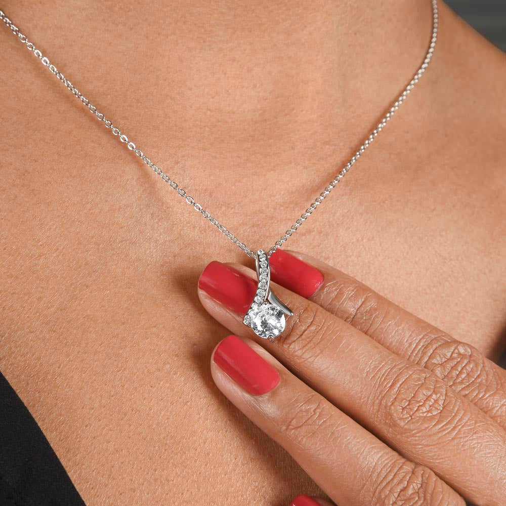 Imagine her reaction when she opens this stunning gift! The Alluring Beauty necklace features a petite ribbon shaped pendant that is sure to dazzle your special someone. Whether it's a birthday or anniversary, make sure to get her a gift she will love for years to come.