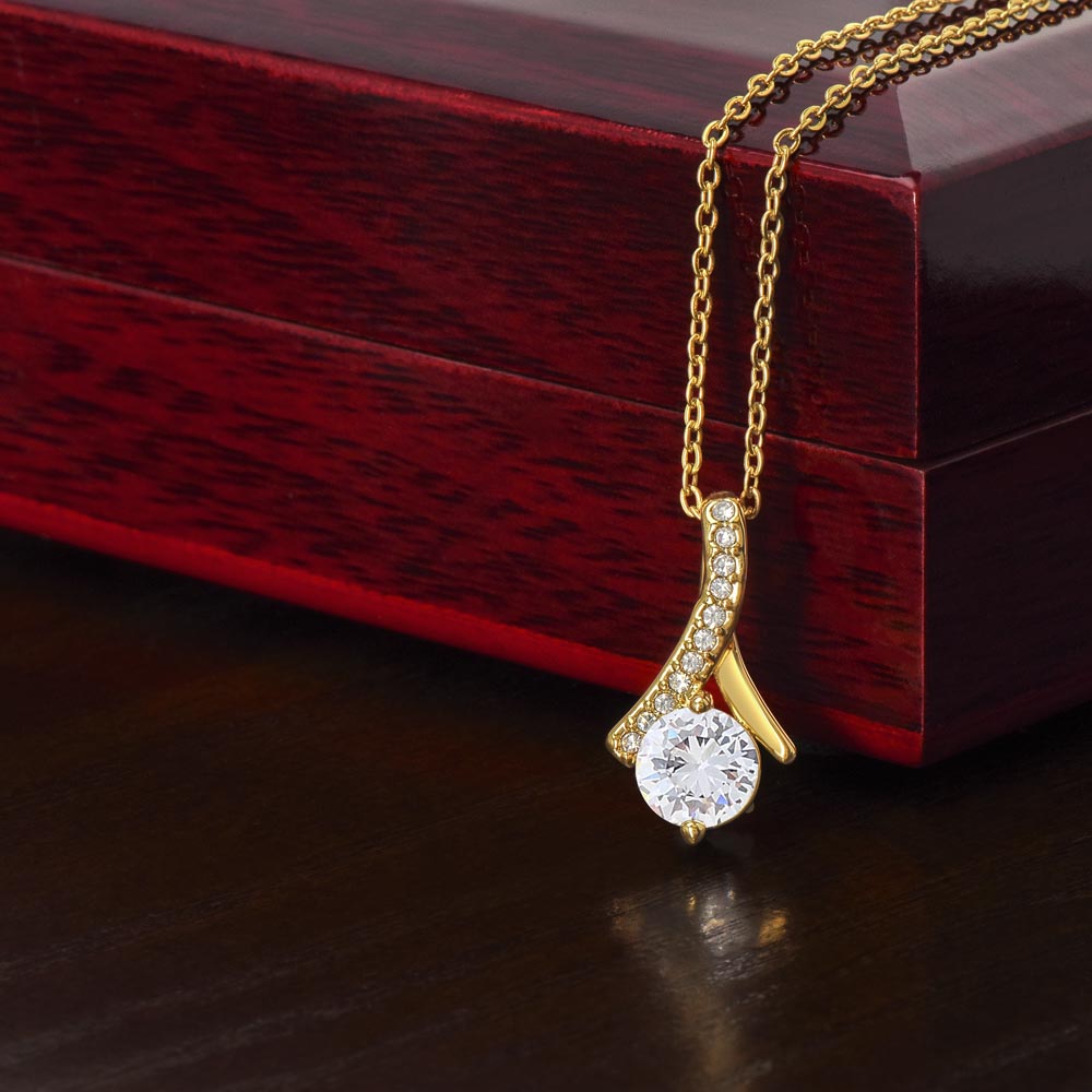 Imagine her reaction when she opens this stunning gift! The Alluring Beauty necklace features a petite ribbon shaped pendant that is sure to dazzle your special someone. Whether it's a birthday or anniversary, make sure to get her a gift she will love for years to come.