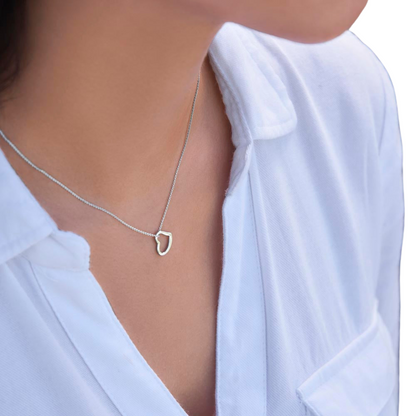 Imagine her delight when she sees this beautiful Delicate Heart Necklace, lovingly crafted in sterling silver and dipped in 14k white gold or 18k yellow gold for added luxury. This piece is pure elegance wrapped up in timeless simplicity. Trends may come and go, but this piece will last a lifetime with its classic subtle beauty.