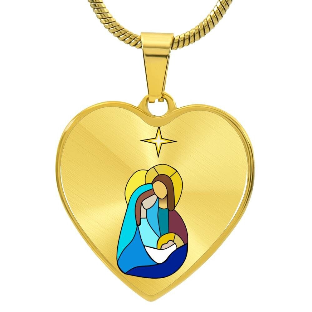 A gold heart-shaped pendant featuring a graphic of the Holy Family with a Christmas tree in the background.