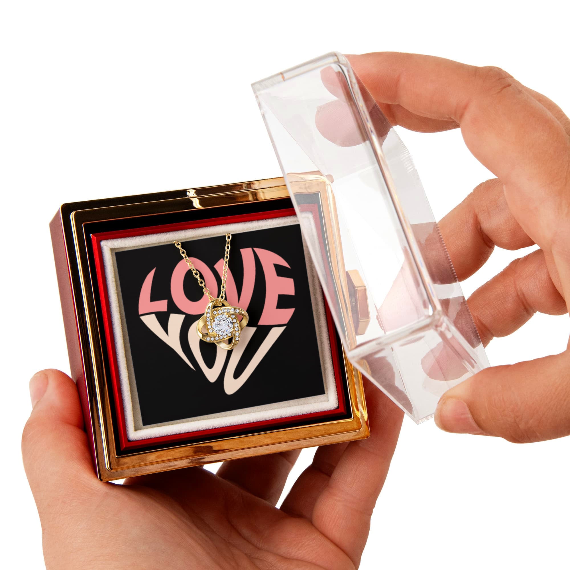 Imagine her reaction as she receives this beautiful Love Knot Necklace. Representing an unbreakable bond between two souls, this stunning pendant is adorned with premium cubic zirconia crystals, making it a timeless symbol of love and devotion. The luxurious box, featuring a meticulously preserved rose that never fades, adds an extra touch of love. With a simple turn of the gold knob, her breathtaking gift is revealed—making it the perfect sentimental gift for that special someone.