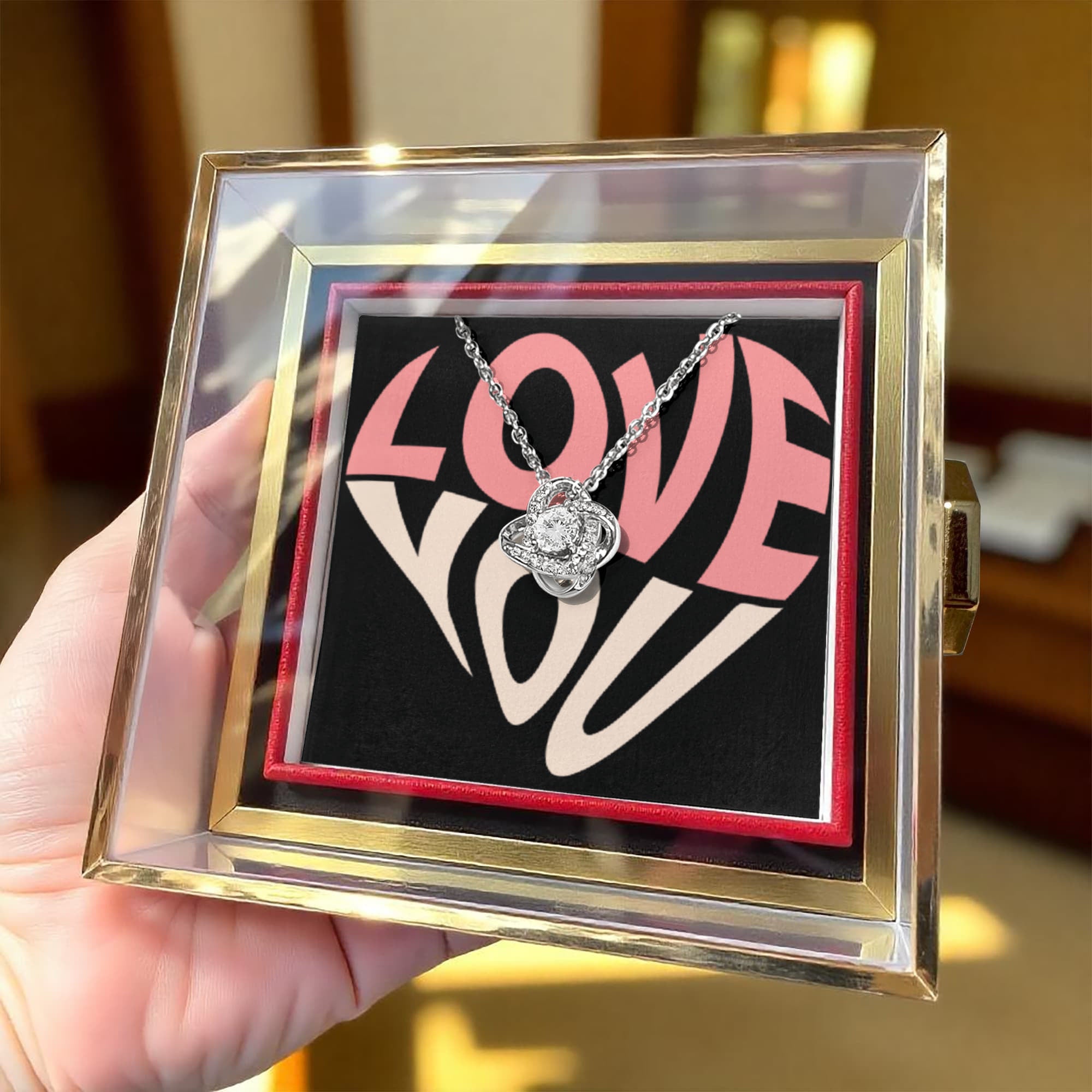 Imagine her reaction as she receives this beautiful Love Knot Necklace. Representing an unbreakable bond between two souls, this stunning pendant is adorned with premium cubic zirconia crystals, making it a timeless symbol of love and devotion. The luxurious box, featuring a meticulously preserved rose that never fades, adds an extra touch of love. With a simple turn of the gold knob, her breathtaking gift is revealed—making it the perfect sentimental gift for that special someone.