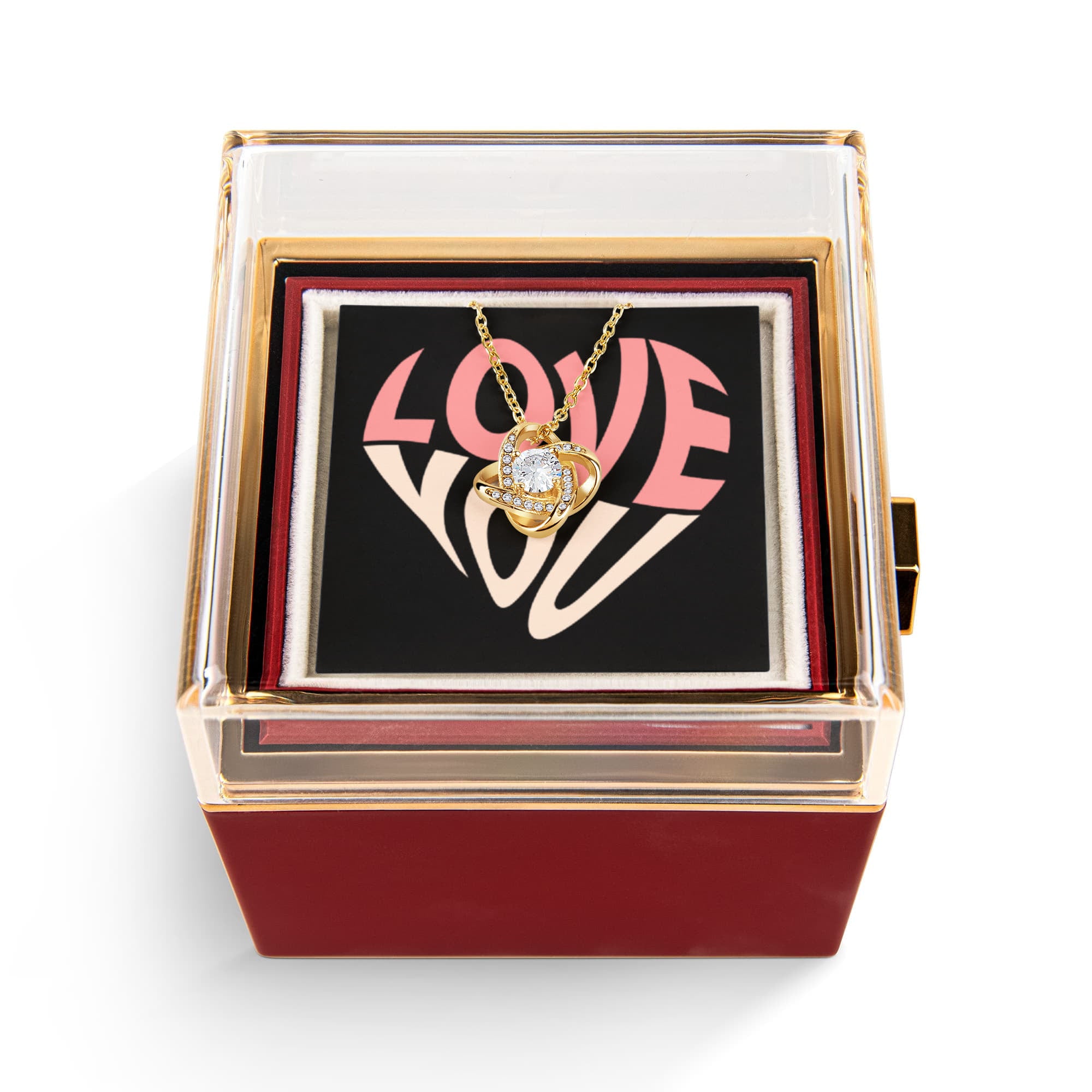 Imagine her reaction as she receives this beautiful Love Knot Necklace. Representing an unbreakable bond between two souls, this stunning pendant is adorned with premium cubic zirconia crystals, making it a timeless symbol of love and devotion. The luxurious box, featuring a meticulously preserved rose that never fades, adds an extra touch of love. With a simple turn of the gold knob, her breathtaking gift is revealed—making it the perfect sentimental gift for that special someone.