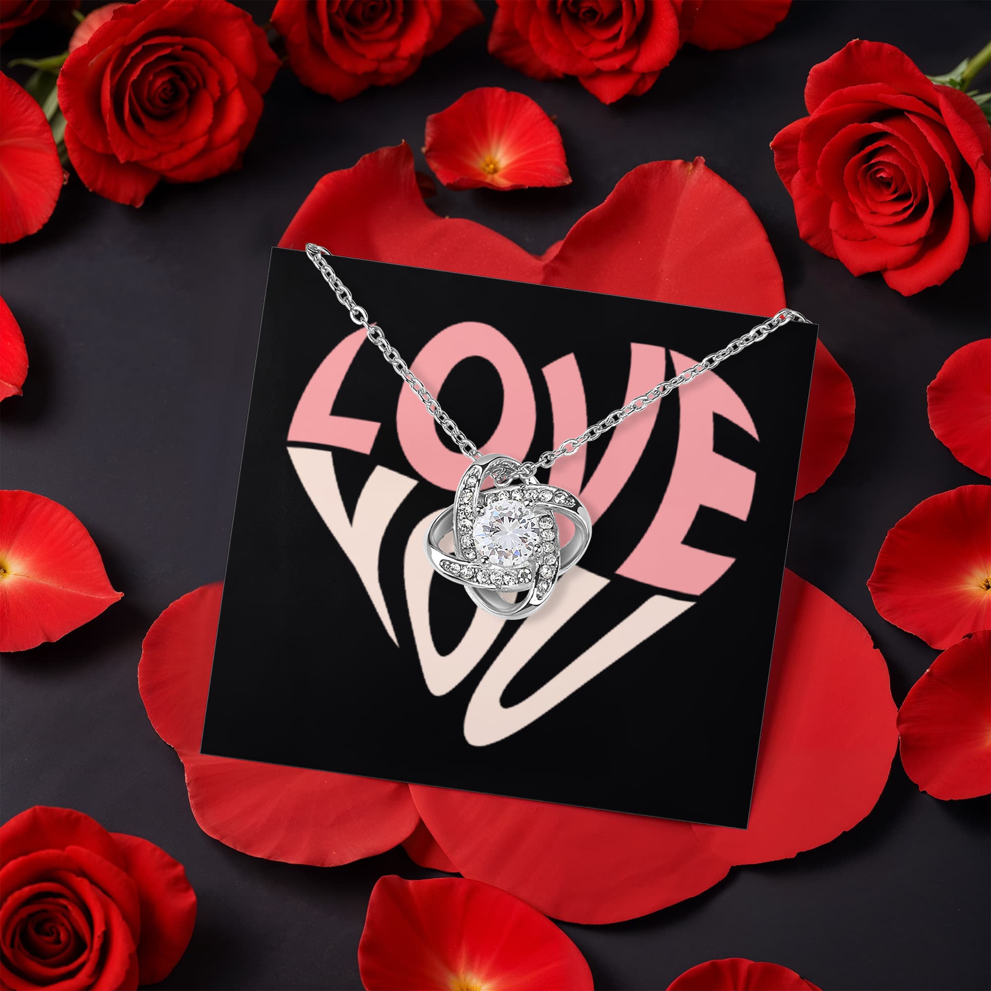 Imagine her reaction as she receives this beautiful Love Knot Necklace. Representing an unbreakable bond between two souls, this stunning pendant is adorned with premium cubic zirconia crystals, making it a timeless symbol of love and devotion. The luxurious box, featuring a meticulously preserved rose that never fades, adds an extra touch of love. With a simple turn of the gold knob, her breathtaking gift is revealed—making it the perfect sentimental gift for that special someone.
