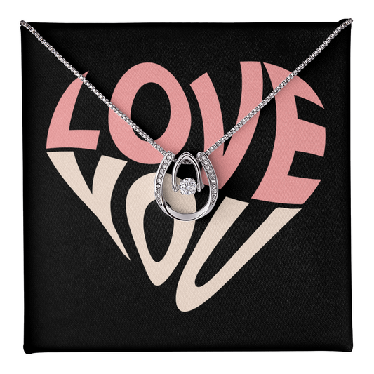 Hand crafted details make this necklace a stand out. This versatile necklace is dipped in white gold and set with shimmering crystals. A dancing center Cubic Zirconia is suspended from two fine points and is designed so as to not touch the skin but continually move in a vibrating fashion.