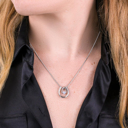 Hand crafted details make this necklace a stand out. This versatile necklace is dipped in white gold and set with shimmering crystals. A dancing center Cubic Zirconia is suspended from two fine points and is designed so as to not touch the skin but continually move in a vibrating fashion.