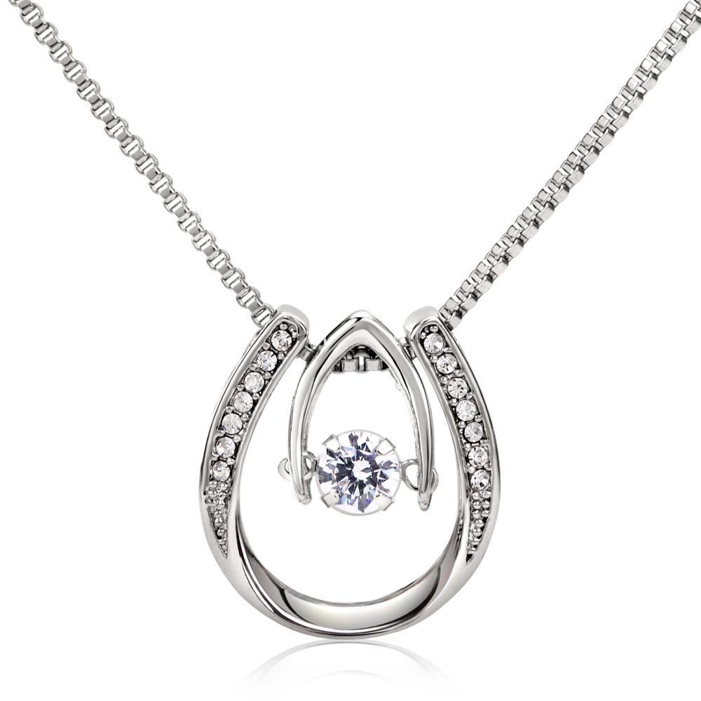 Hand crafted details make this necklace a stand out. This versatile necklace is dipped in white gold and set with shimmering crystals. A dancing center Cubic Zirconia is suspended from two fine points and is designed so as to not touch the skin but continually move in a vibrating fashion.