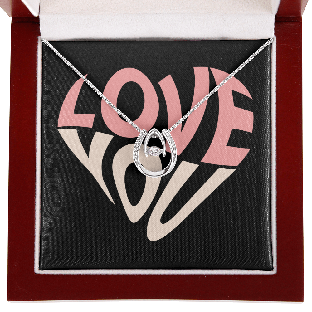 Hand crafted details make this necklace a stand out. This versatile necklace is dipped in white gold and set with shimmering crystals. A dancing center Cubic Zirconia is suspended from two fine points and is designed so as to not touch the skin but continually move in a vibrating fashion.