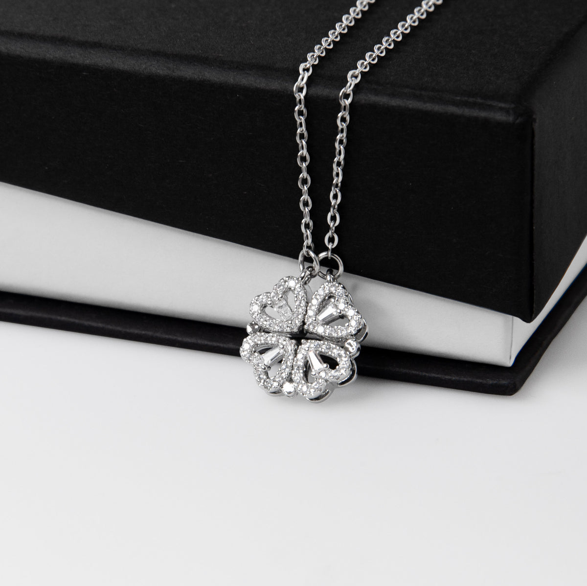 The Magnetic Hearts Necklace features four crystal-embellished hearts that come together to form a beautiful lucky clover. The hidden magnetic design allows each heart to connect seamlessly—symbolizing connection, unity, and the moments that bring us together.