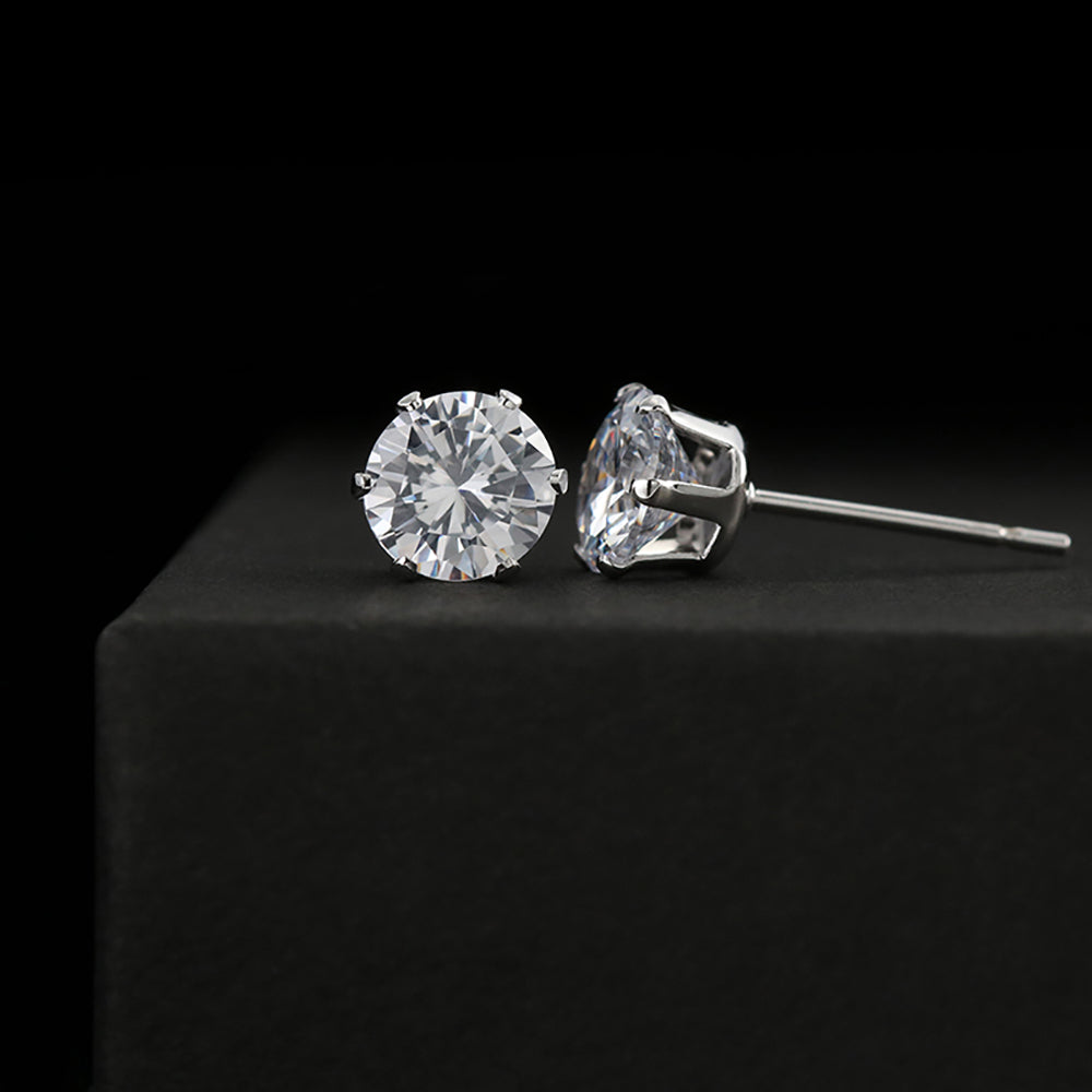 A pair of 6mm cubic zirconia stud earrings with 14K white gold dipped settings, displayed against a black background.